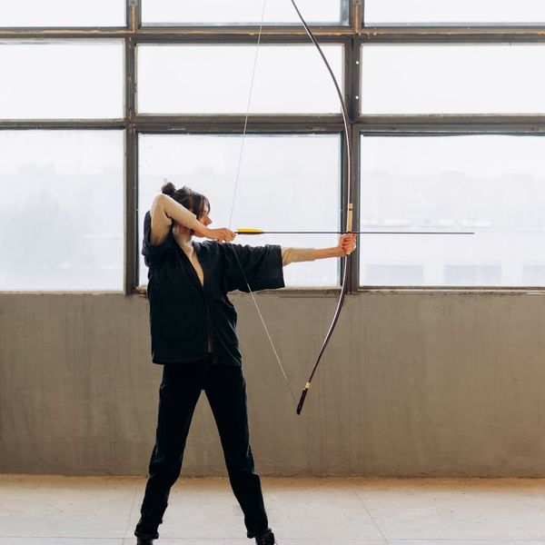 Person practicing a balancing pose with focus and stability.